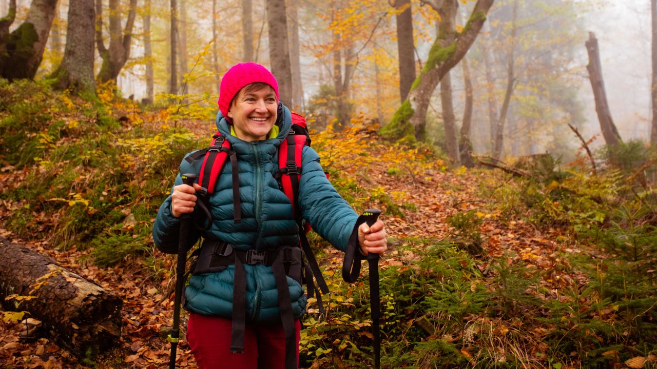 Hiker on a coastal trail in autumn