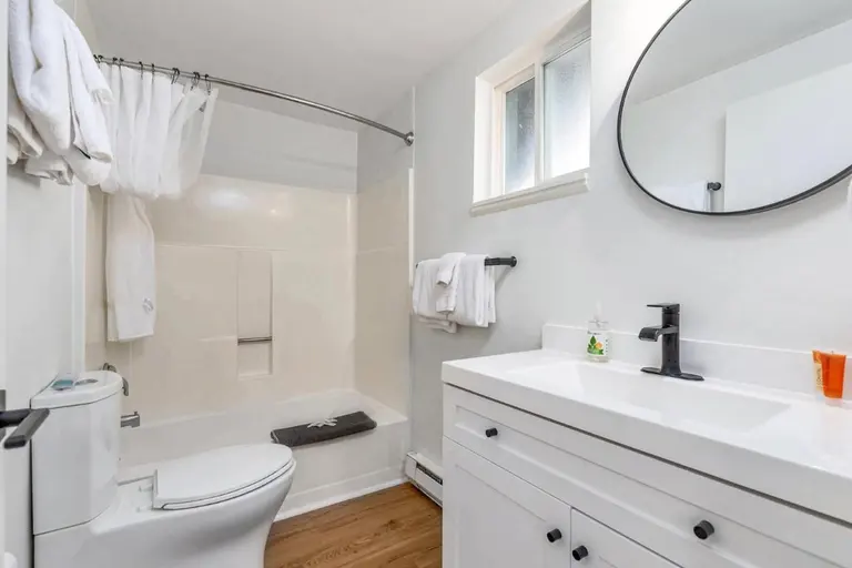 Bathroom with a tub and vanity in Tidal House Chalet 1.