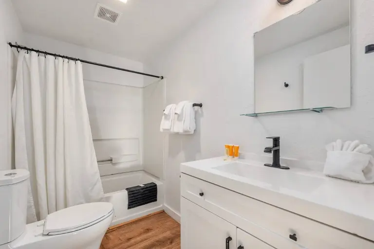 Bathroom with a tub and vanity in Tidal House Chalet 5.