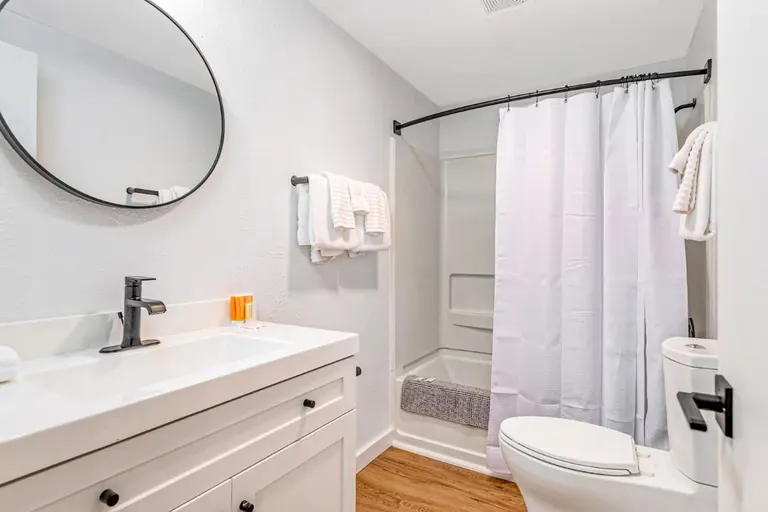 Bathroom with a tub and vanity in Tidal House Chalet 6.