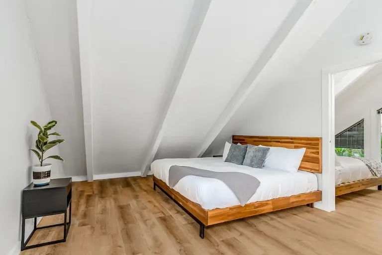First upstairs bedroom with the second bedroom visible in Tidal House Chalet 7.