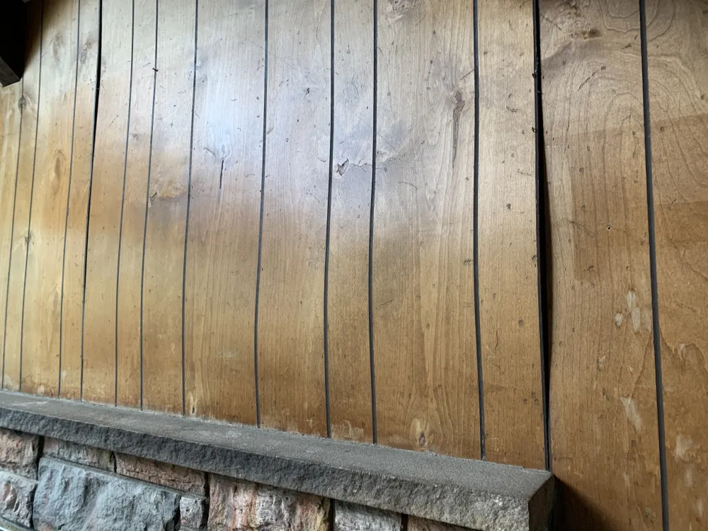 Original wood paneling above Unit 4’s fireplace