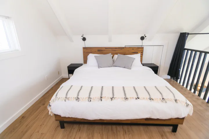 Loft bedroom inside a Tidal House A-frame cottage